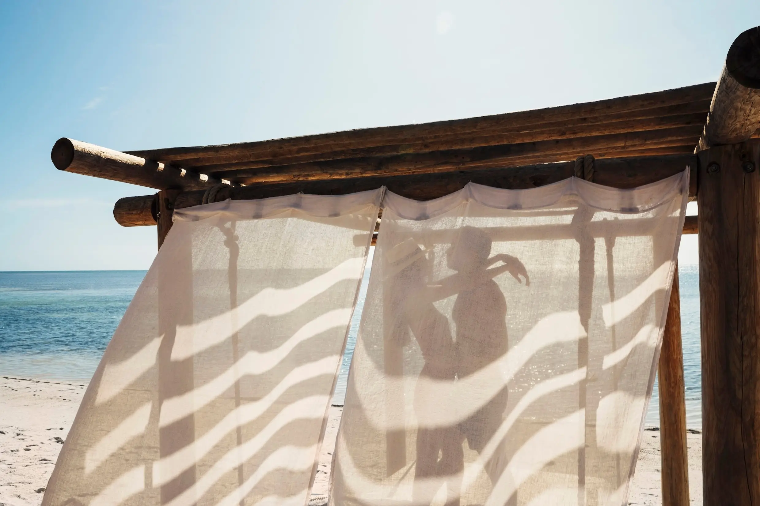 A couple inside a beachfront cabana on Little Palm Island