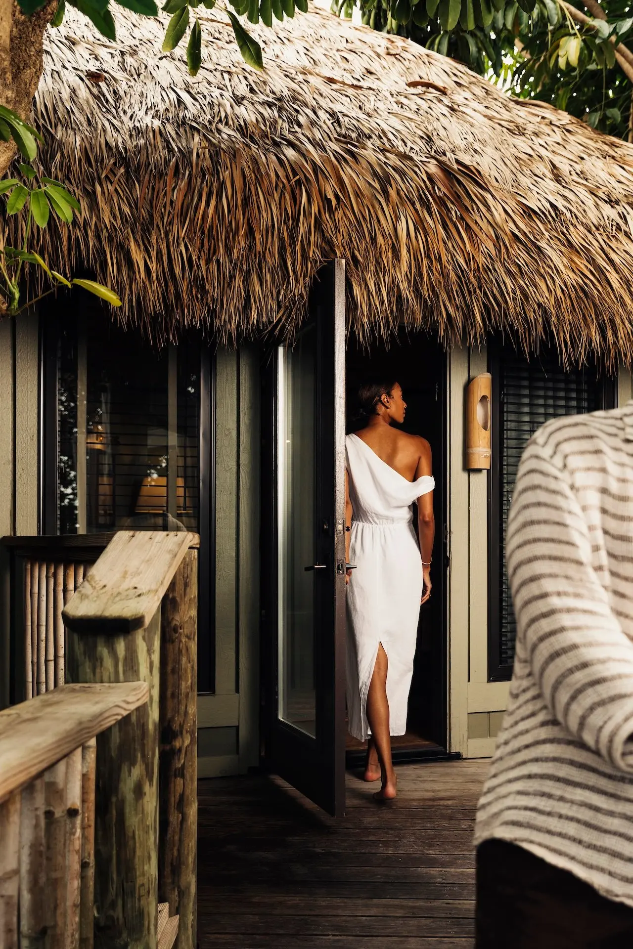 A person walking into the room at Little Palm Island wearing a beautiful white dress