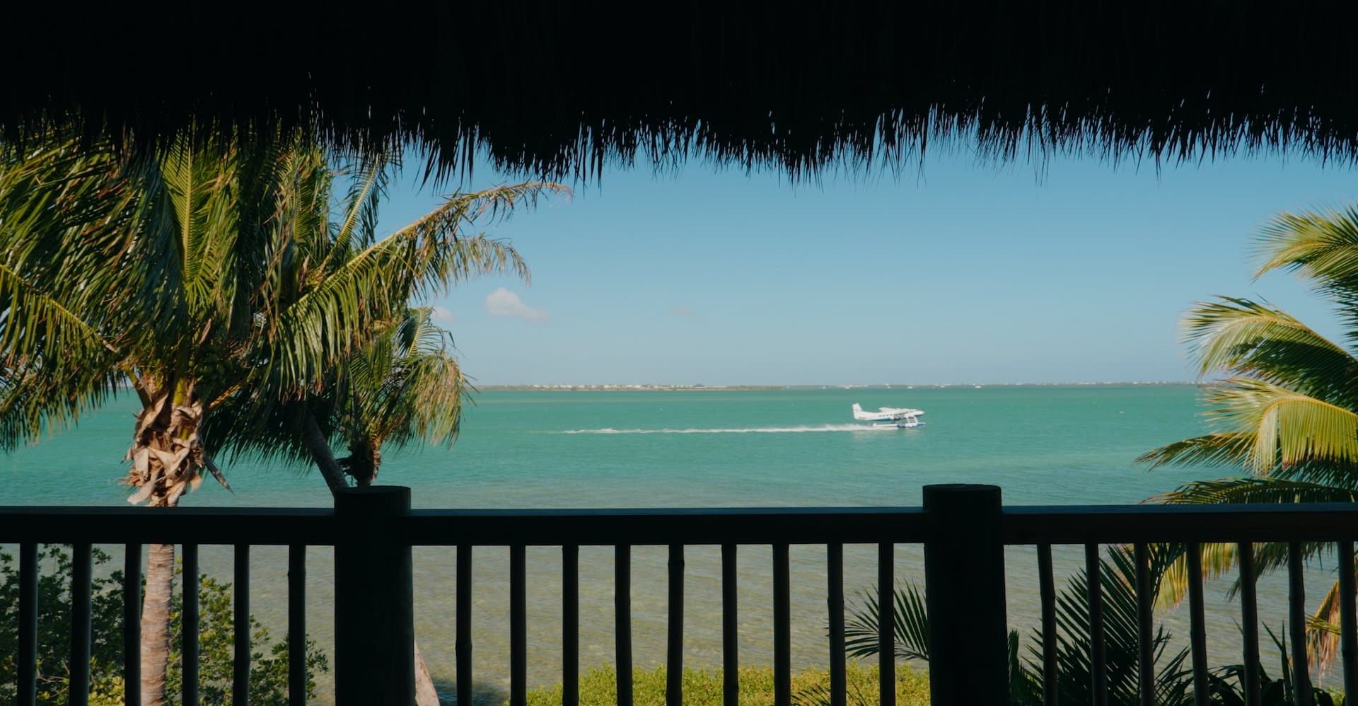 A seaplane landing on the water at Little Palm Island