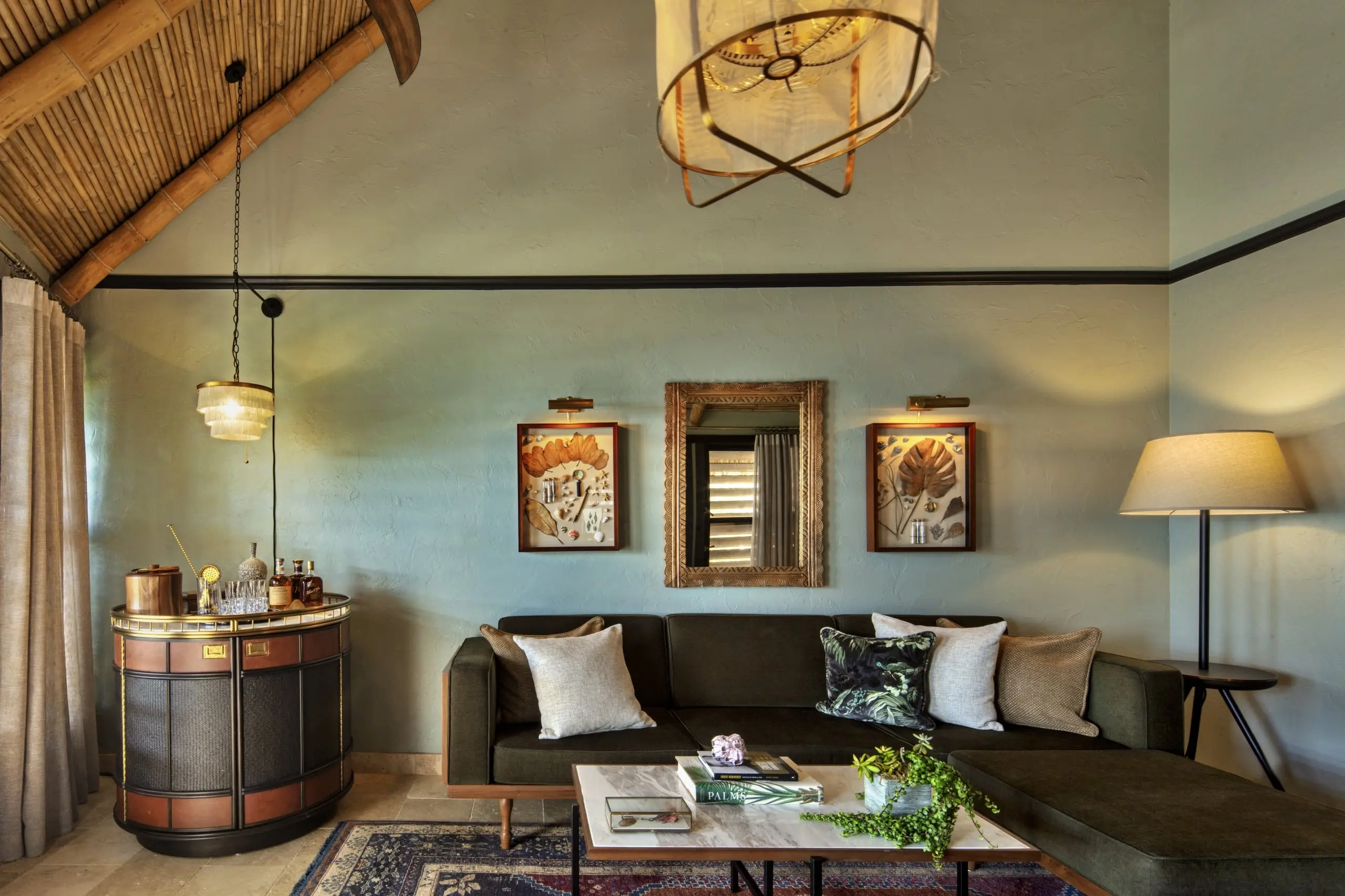 The living room at Little Palm Island with a bar and a sectional sofa