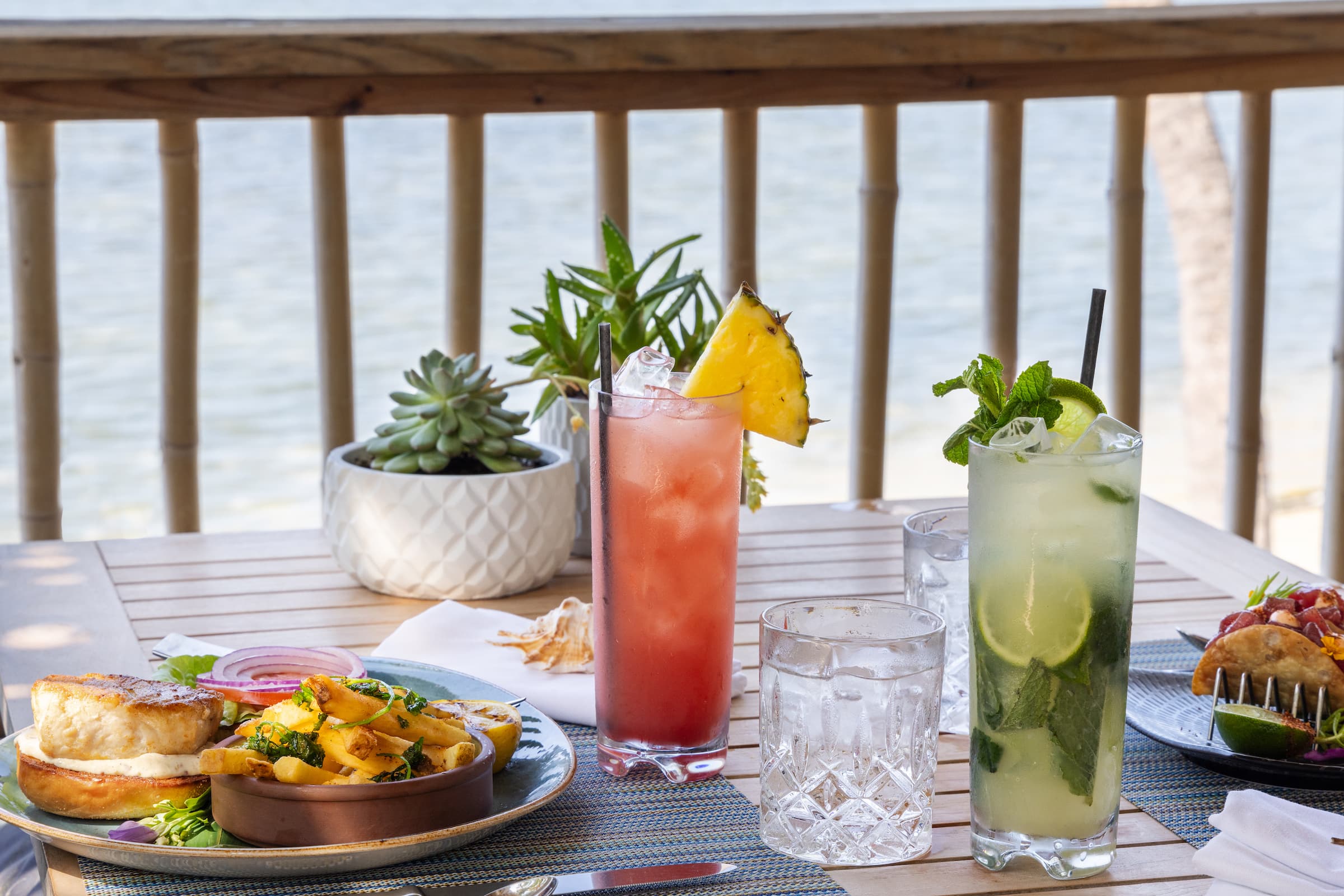 Two cocktails and a meal served from the Palapa Bar