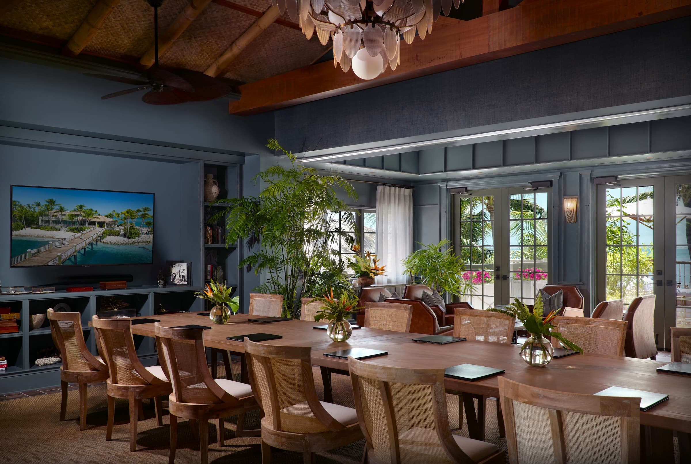 A modern conference room at Little Palm Island Resort with a long table and ocean views