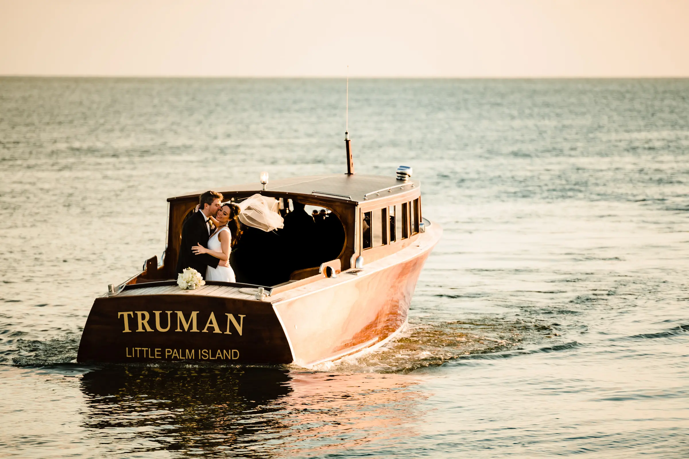 A bride and groom embracing on a private charter from Little Palm Island Resort