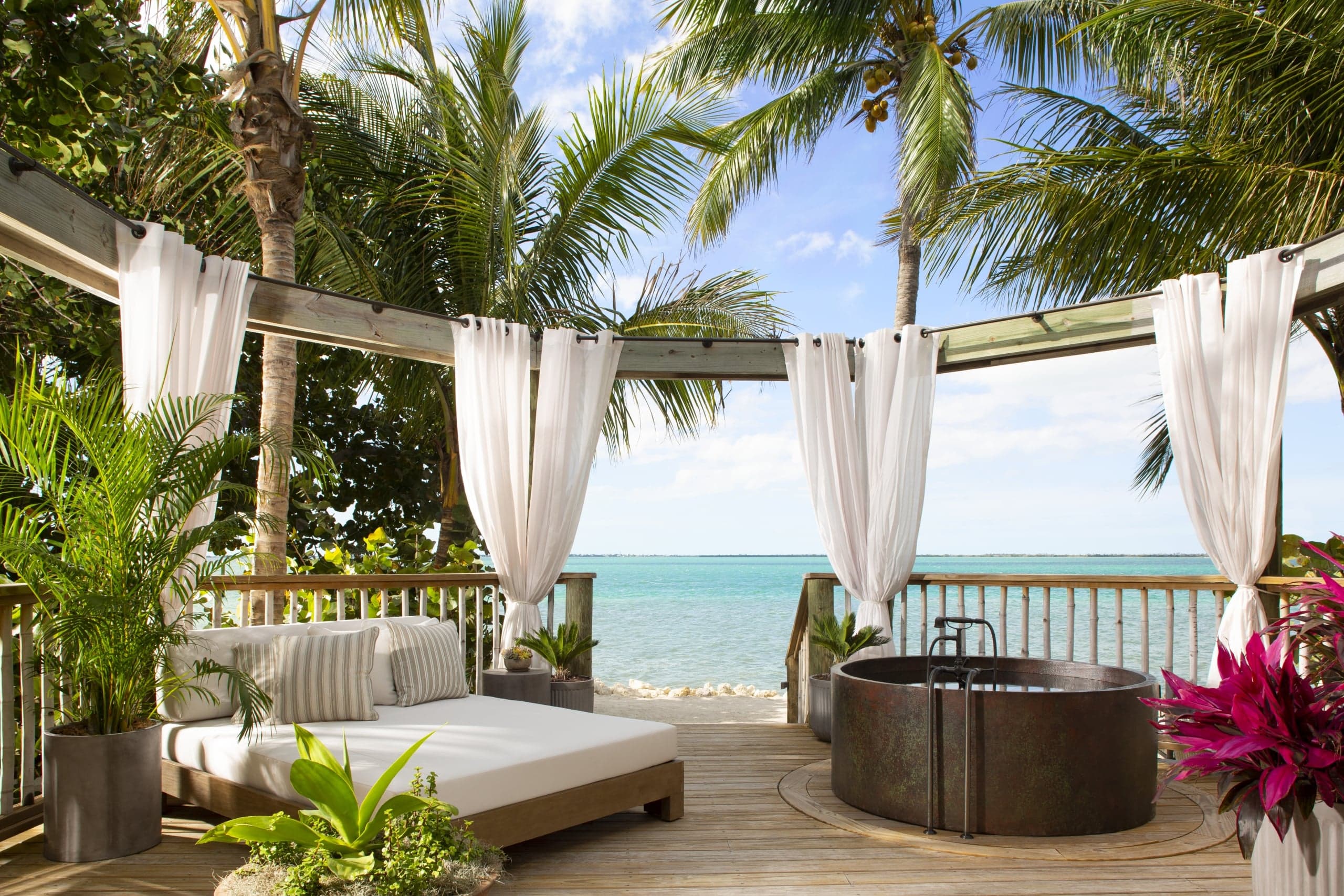 A patio with a soaker tub at Little Palm Island