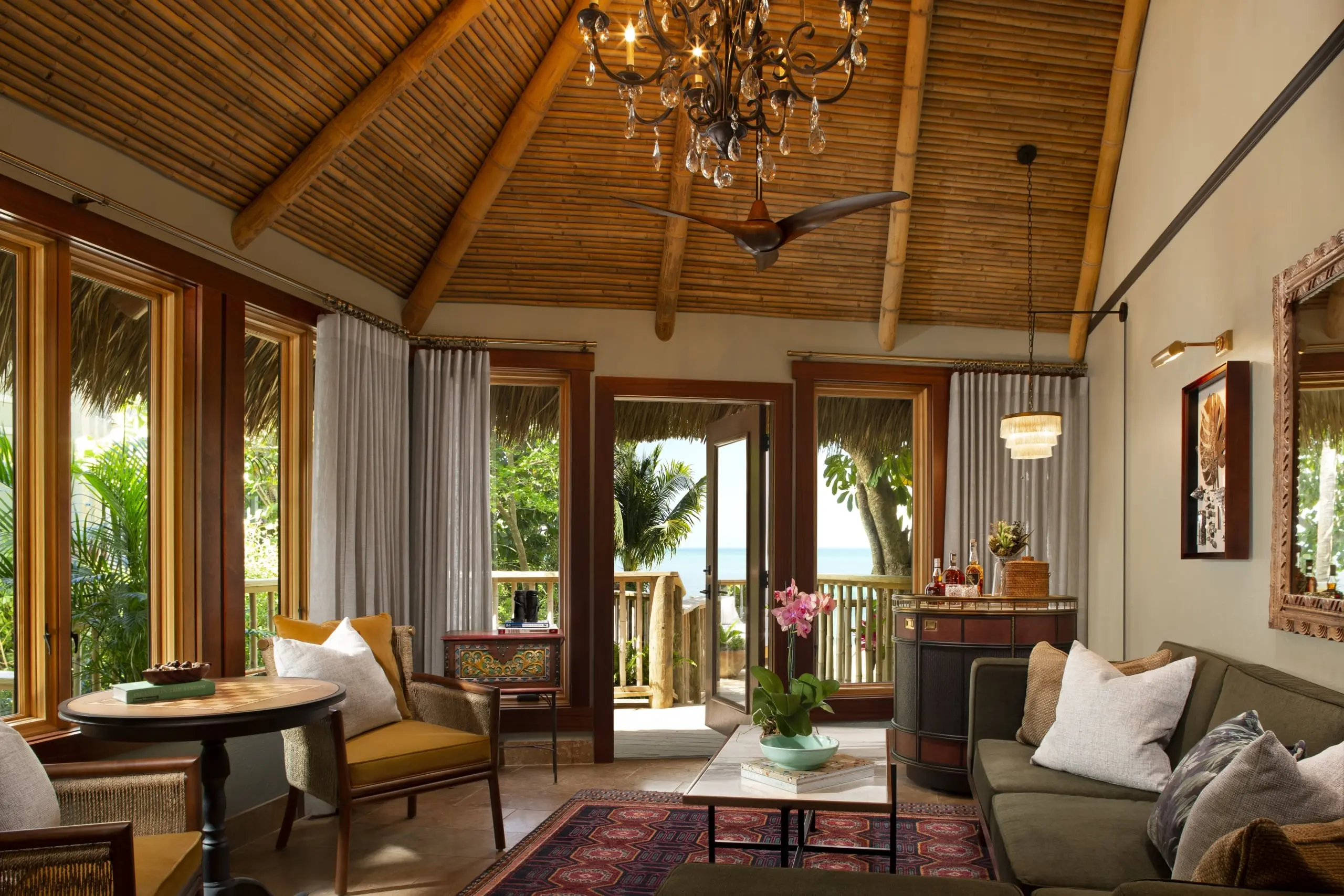 The living space of a suite at Little Palm Island with plenty of sitting space and access to an outdoor space