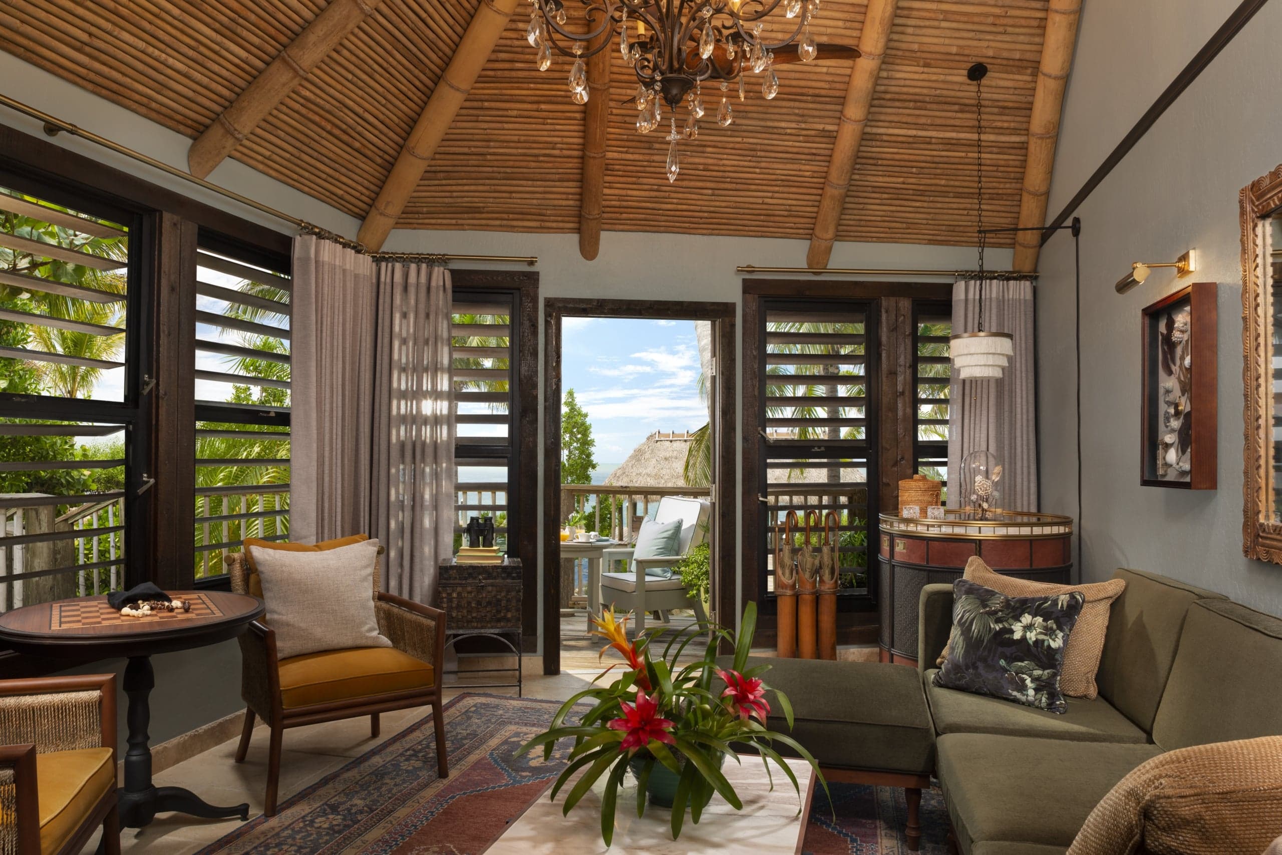 The living space of a suite at Little Palm Island with plenty of sitting space and access to a balcony