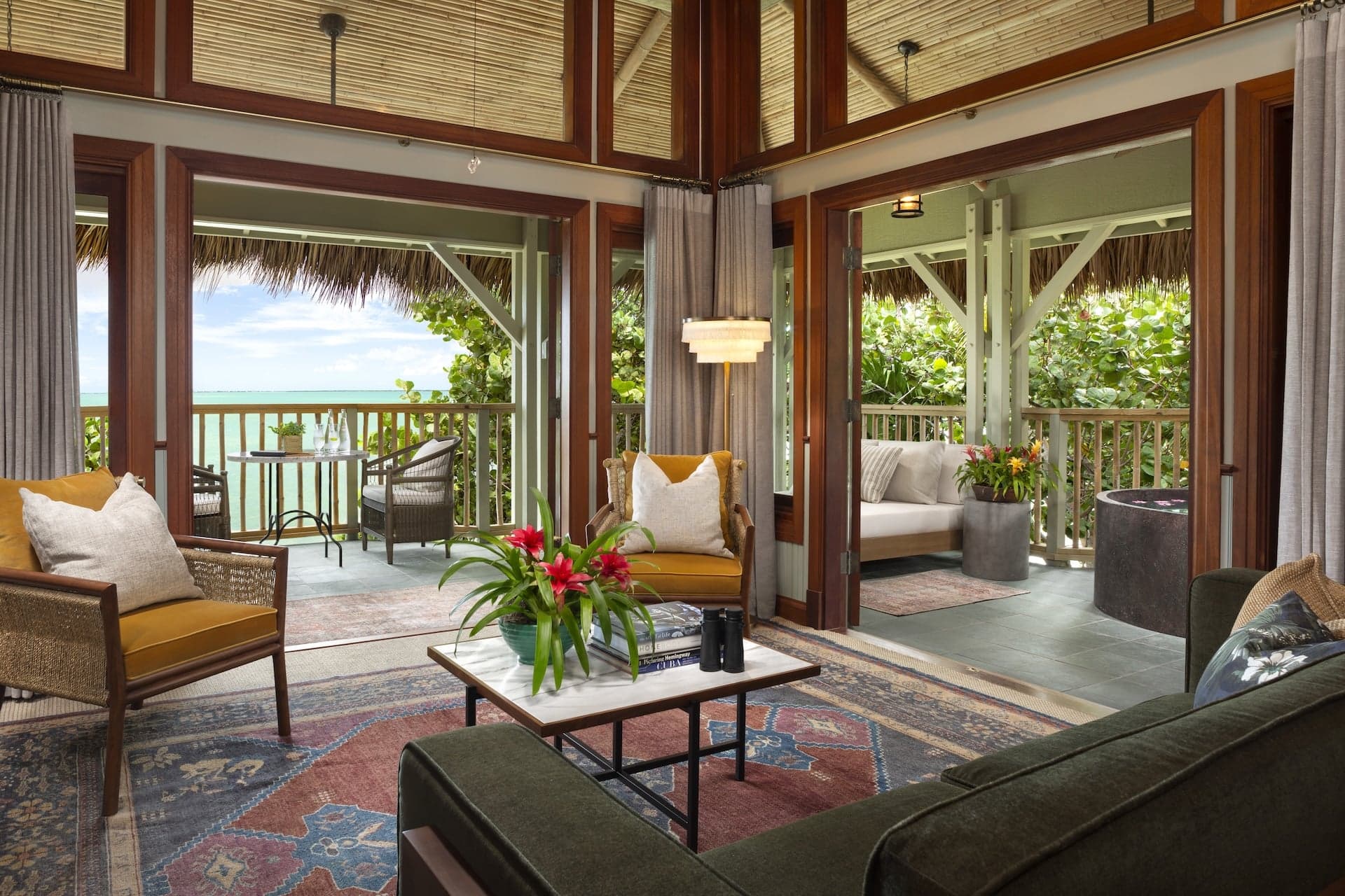 The living area of a suite at Little Palm Island with plenty of sitting space and access to the outdoor space