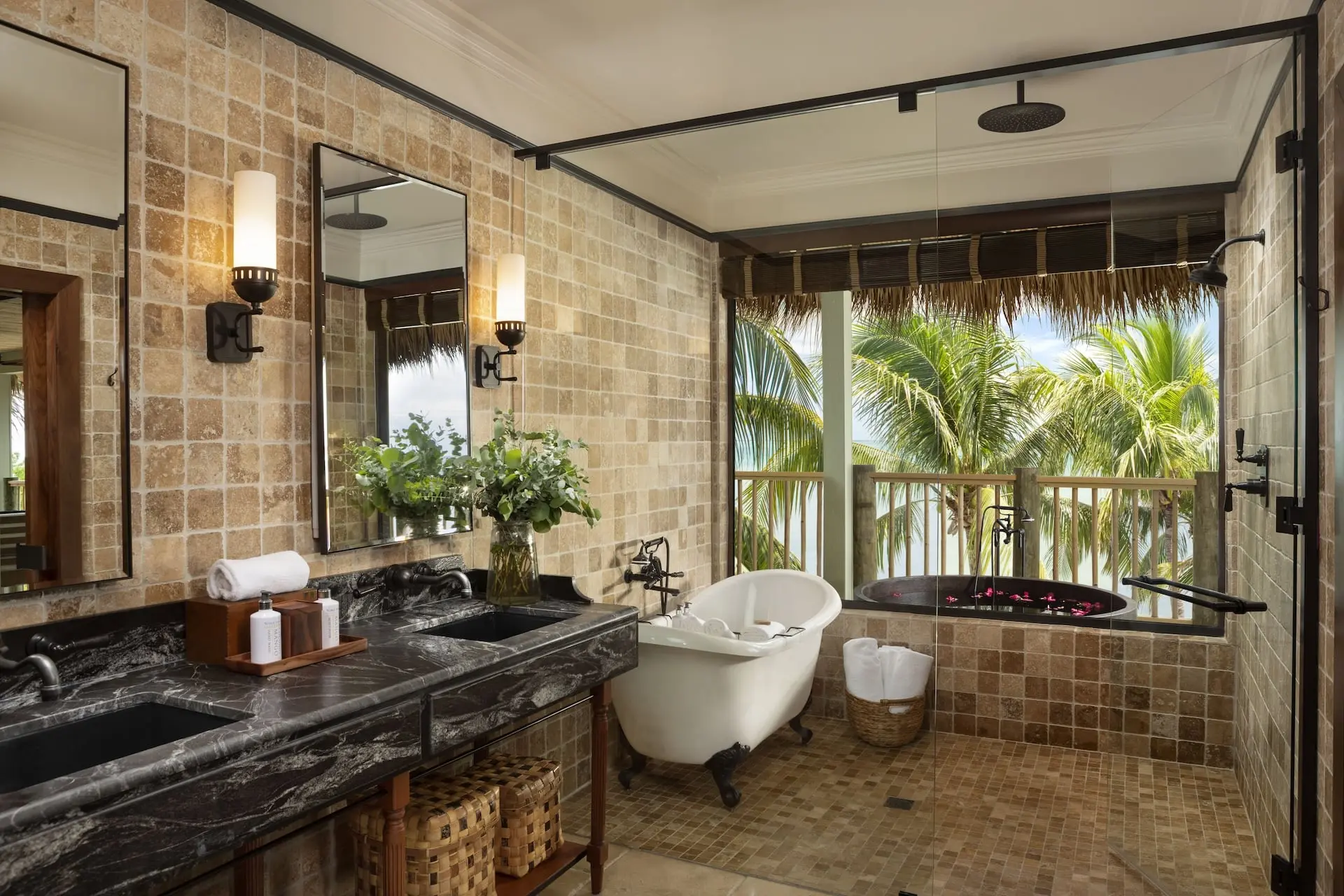 A washroom at at Little Palm Island with a tub and a double sink vanity