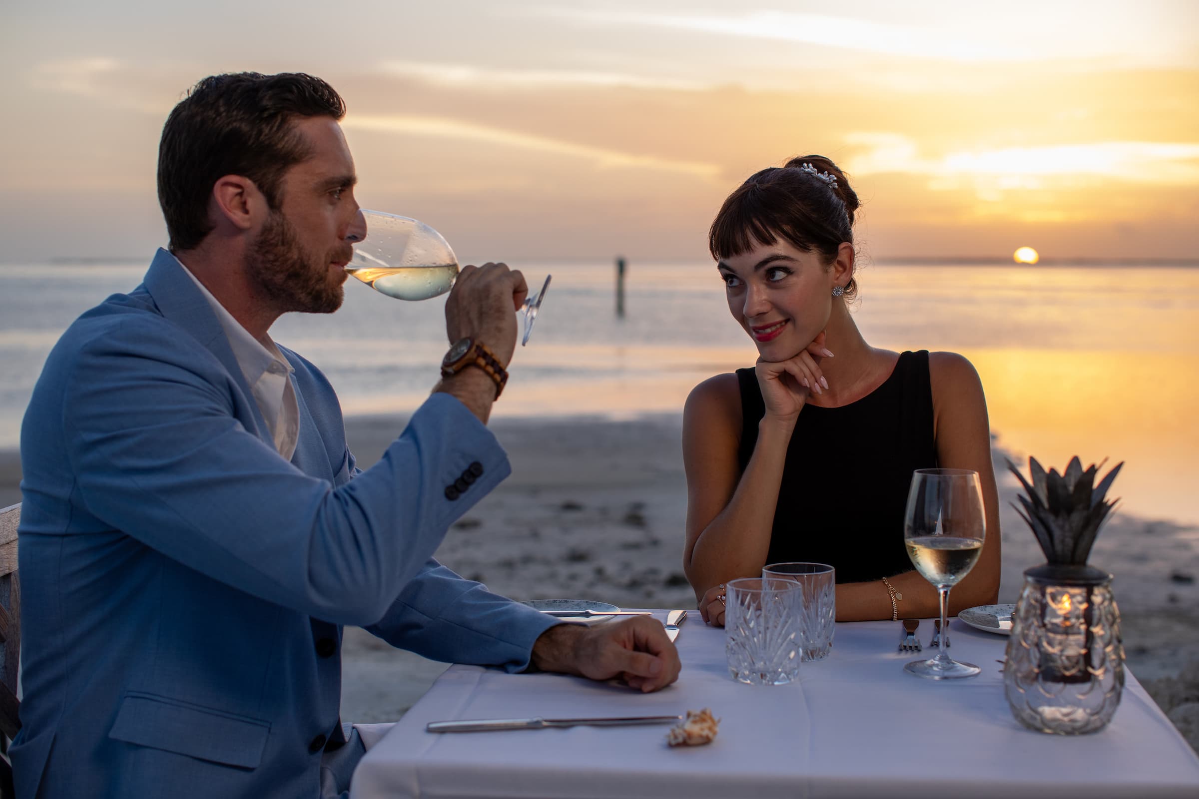 A couple enjoying a beachside dining experience at Little Palm Island Resort