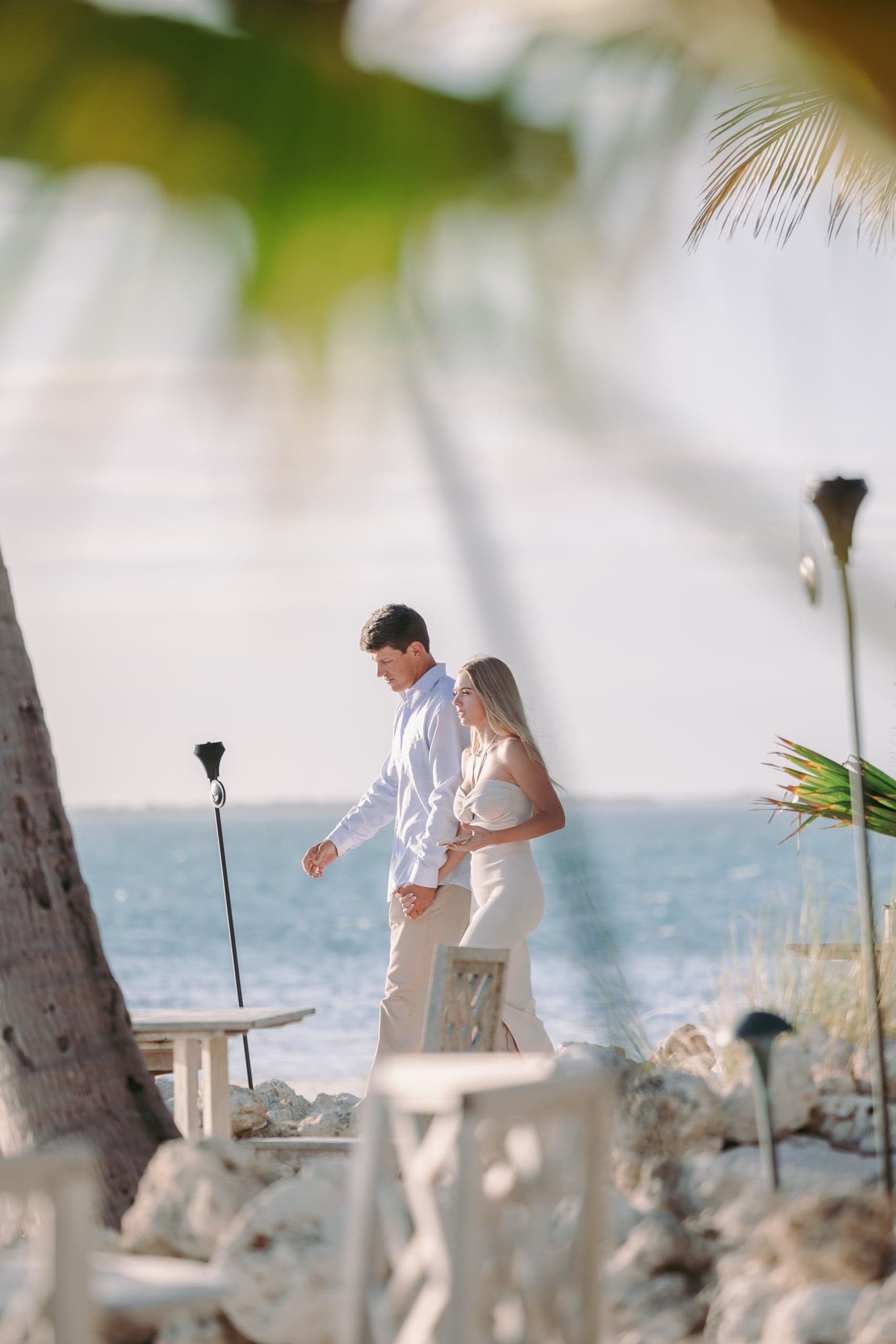 A couple walking the beach at Little Palm Island