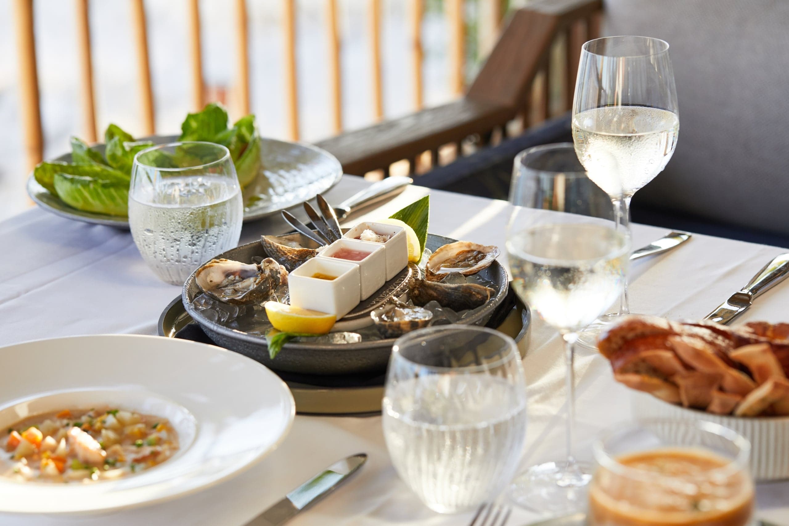 The Chef's Tasting Menu at Little Palm Island served on a dinner table.