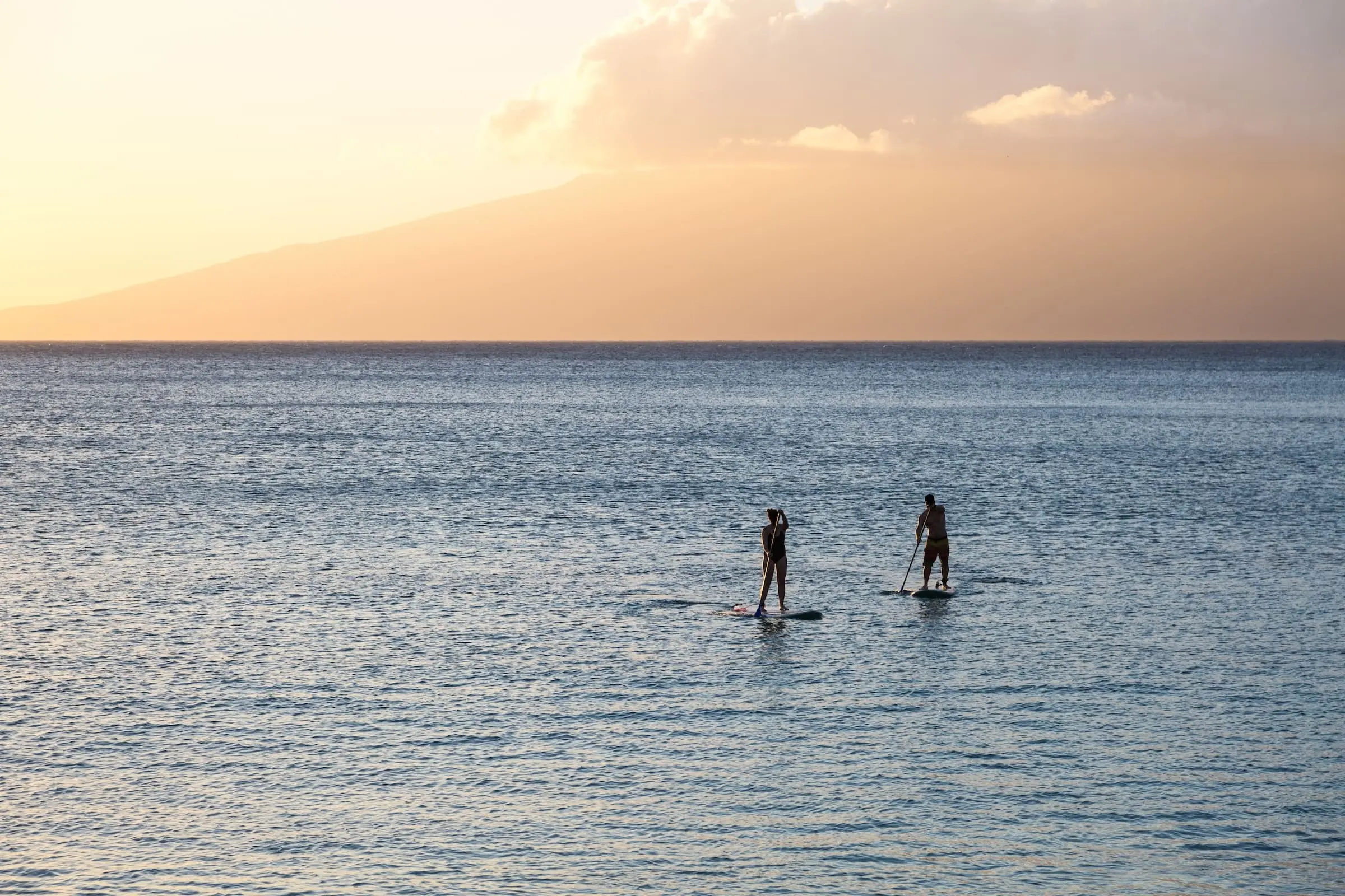 A couple paddle boarding at Little Palm Island Resort