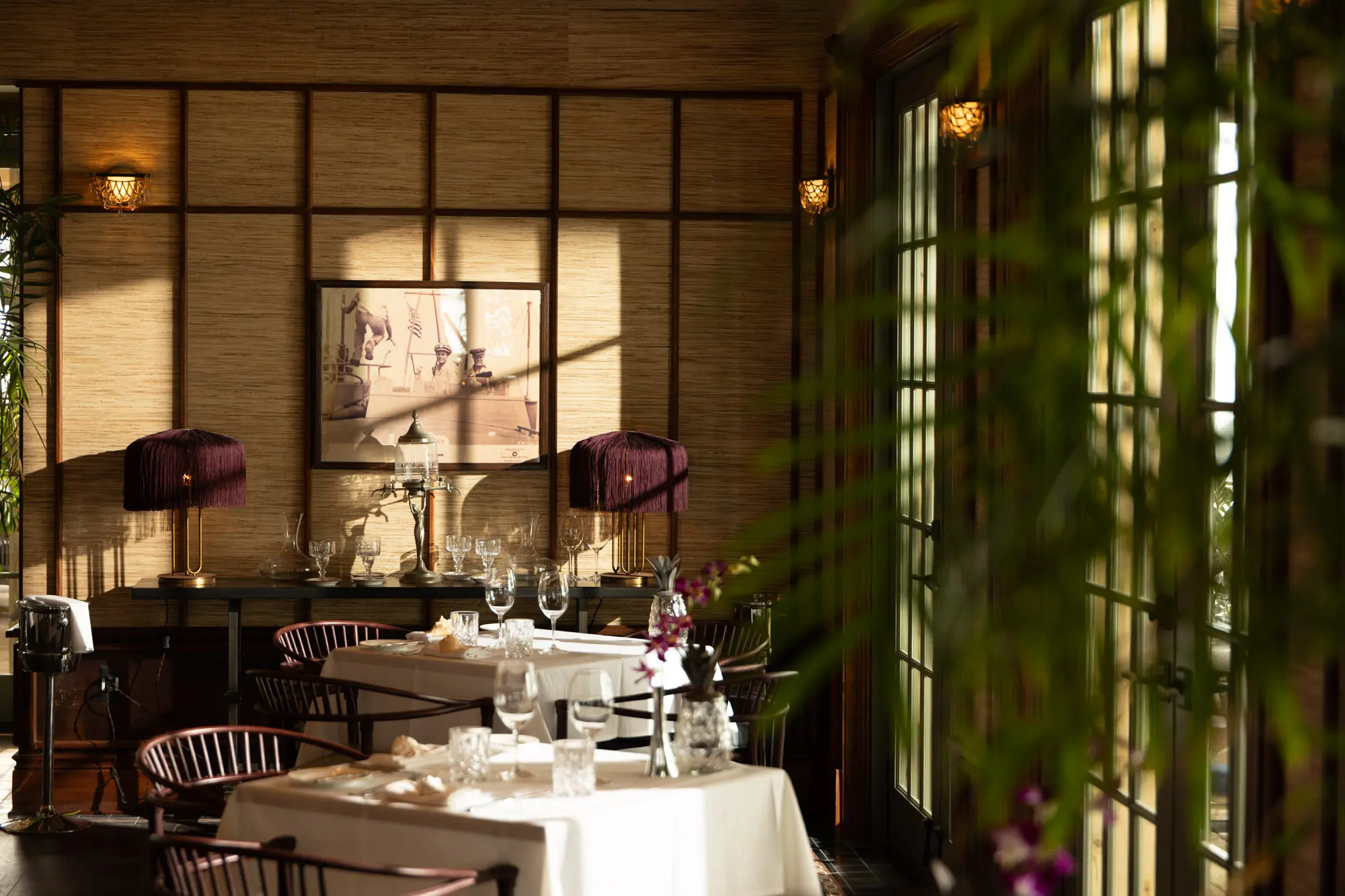 Dinner tables set in the dining room at Little Palm Island