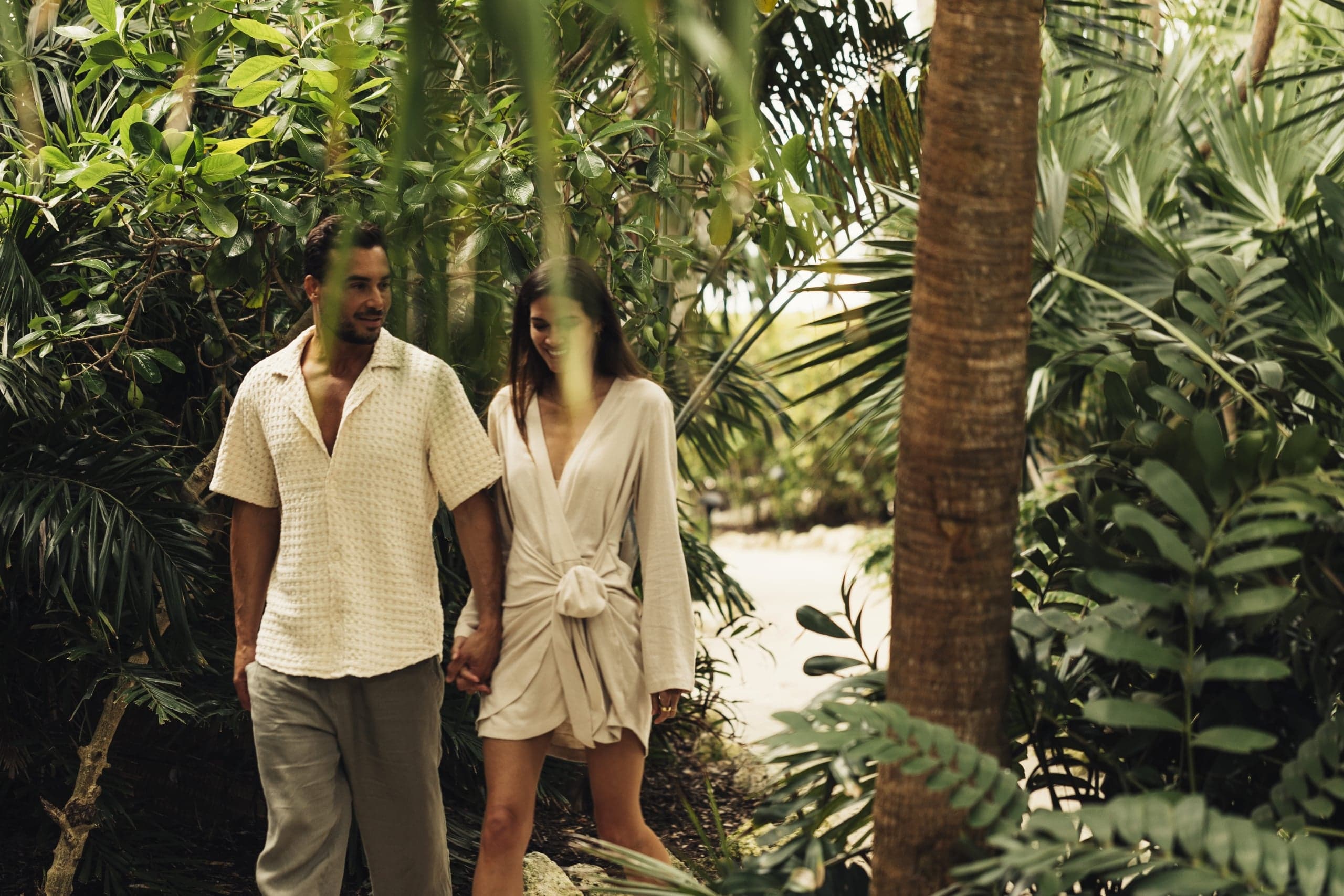 A couple walking through the lush greenery on Little Palm Island