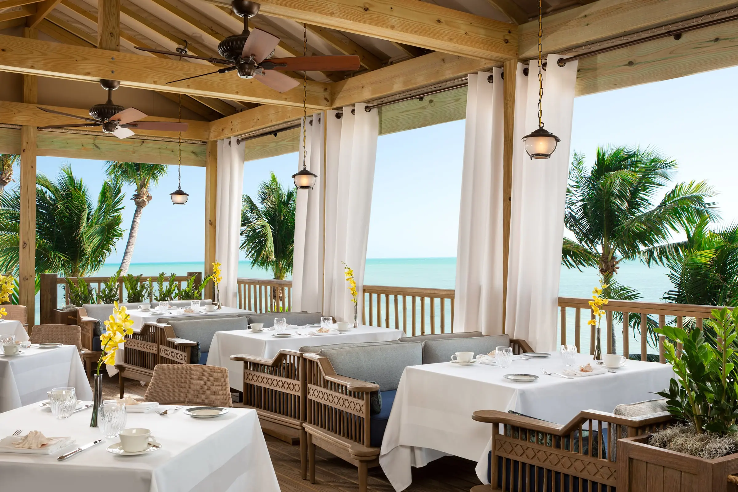 The oceanfront dining room set up for service at Little Palm Island Resort