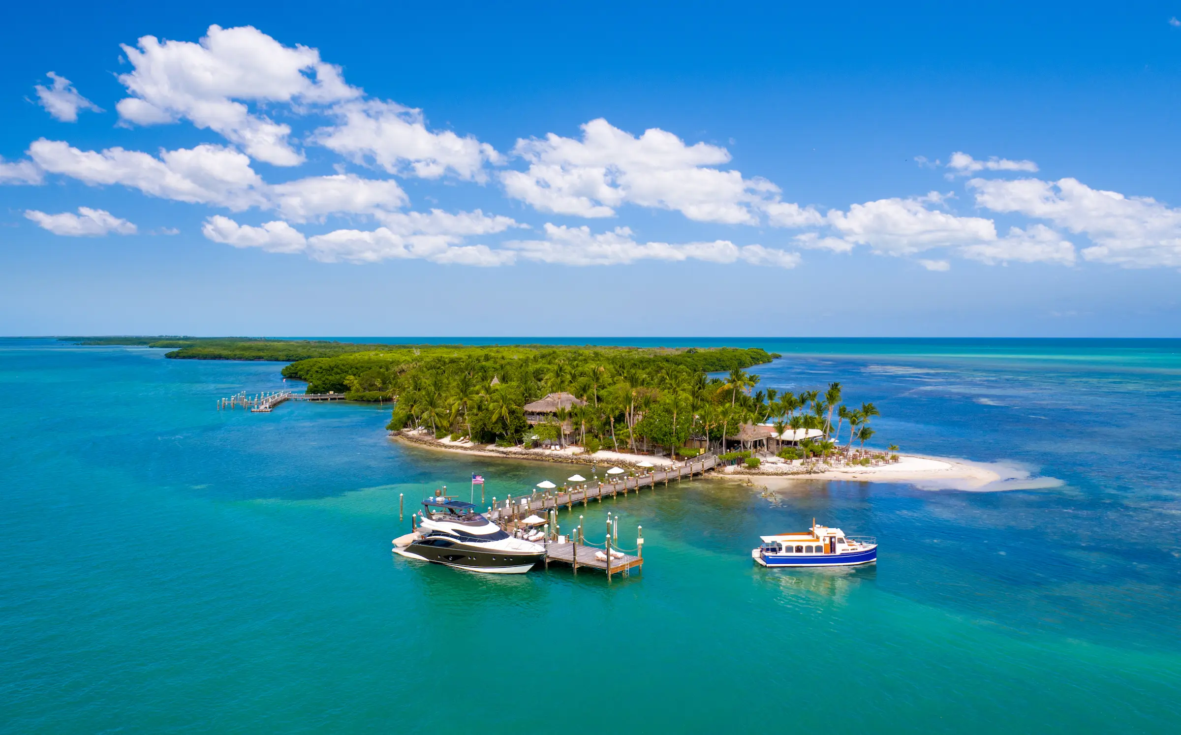 The Marina at Little Palm Island Resort with a yacht docked at the pier